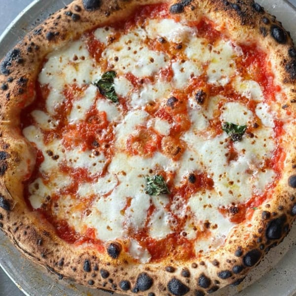 BareBakedPizza's Margherita pizza with a perfectly charred crust, melted mozzarella, and fresh basil.
